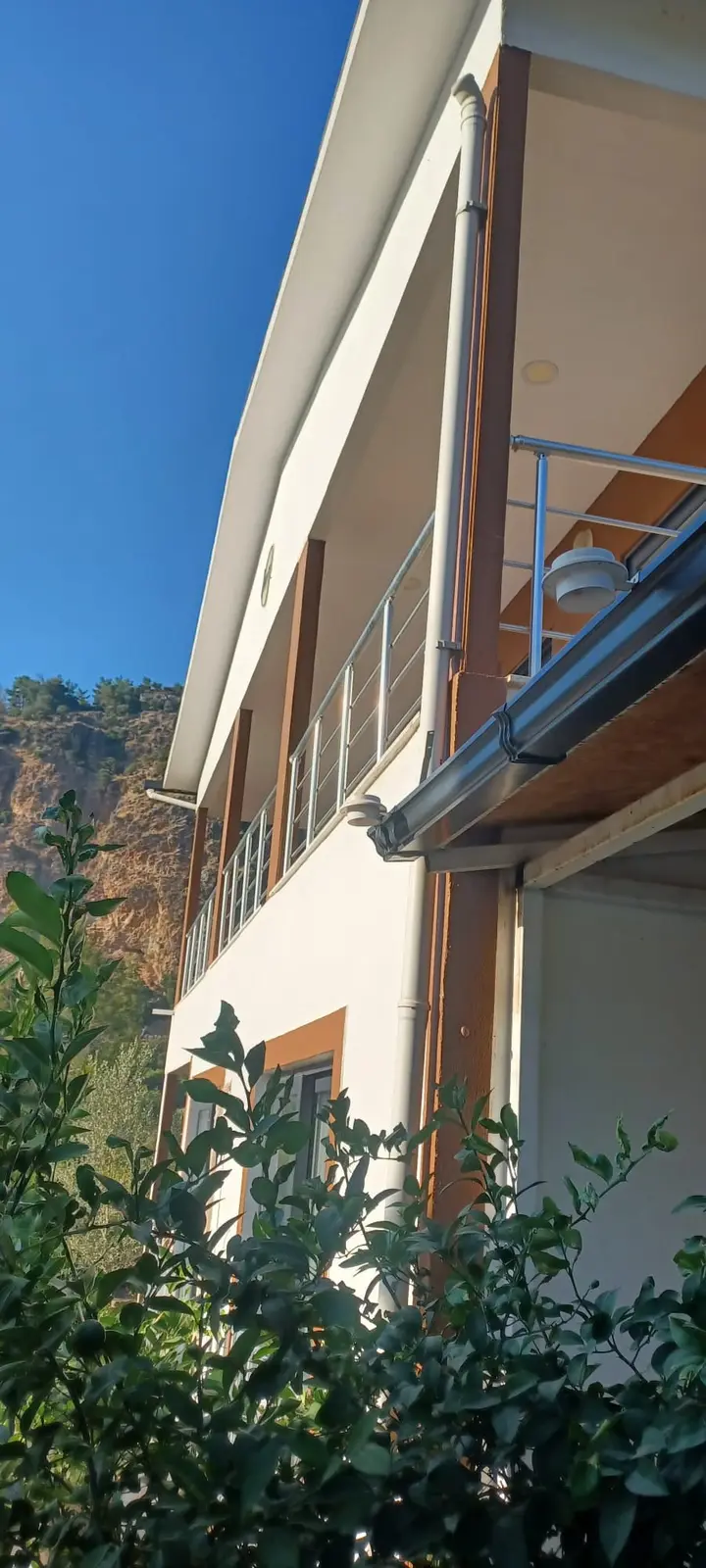 Looking up the side of the house to the upper-floor balcony