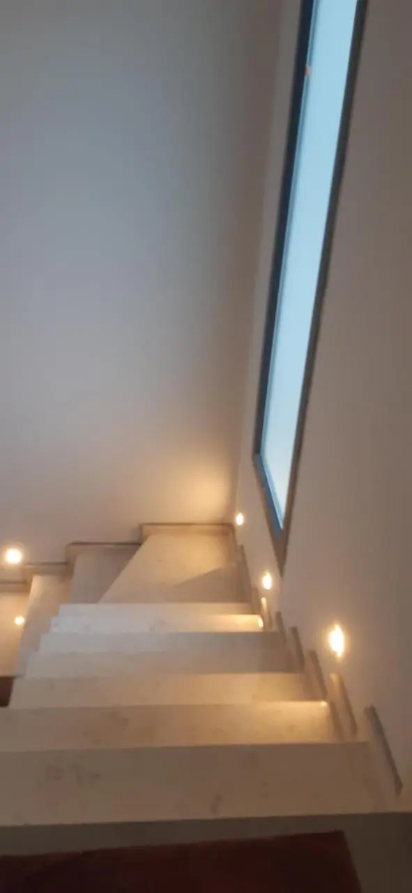 Stone staircase with step lights leading up to the apartment